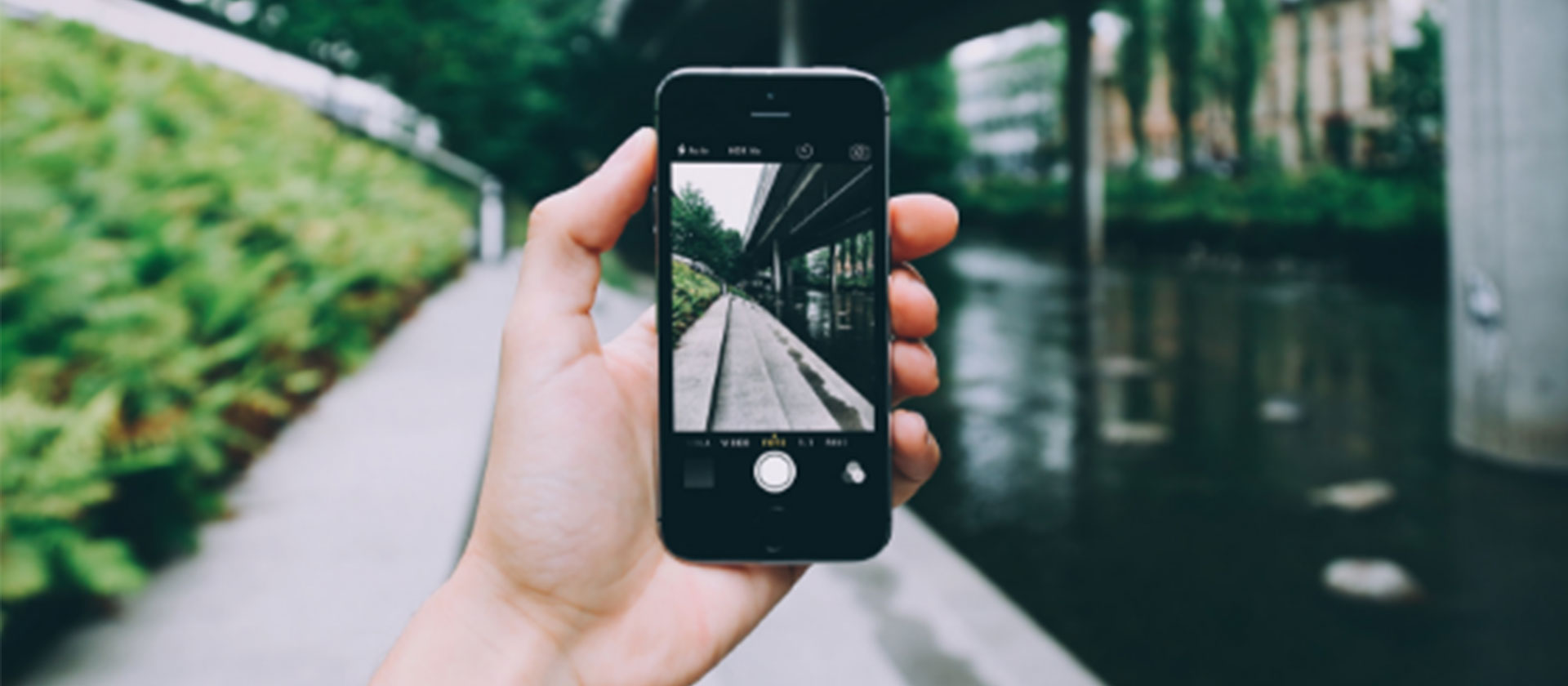 A man with an Apple iphone taking a picture